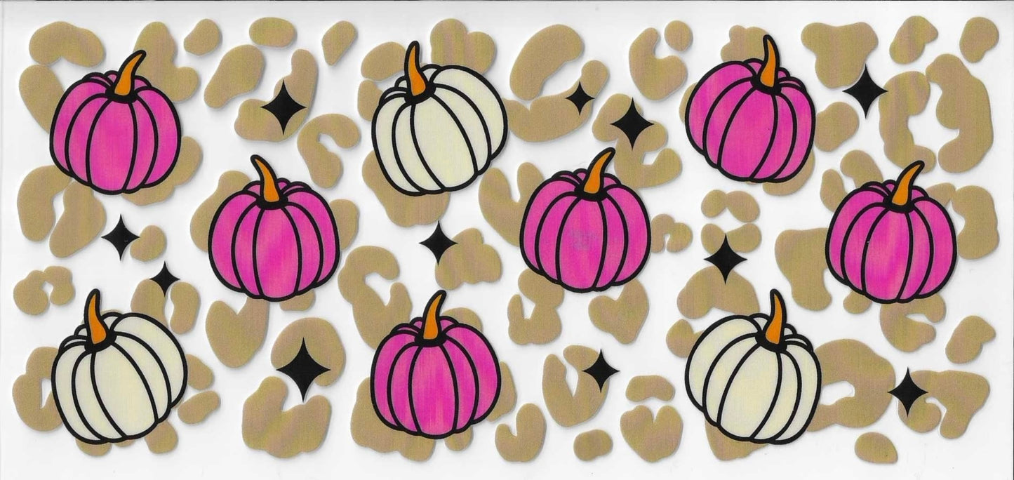 Pattern of pink and white pumpkins on a beige background with black stars.