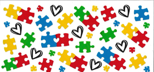 Colorful puzzle pieces and hearts on a white background