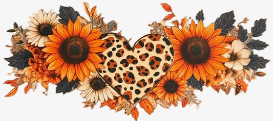 Heart-shaped leopard print pillow surrounded by sunflowers and fall leaves on a white background
